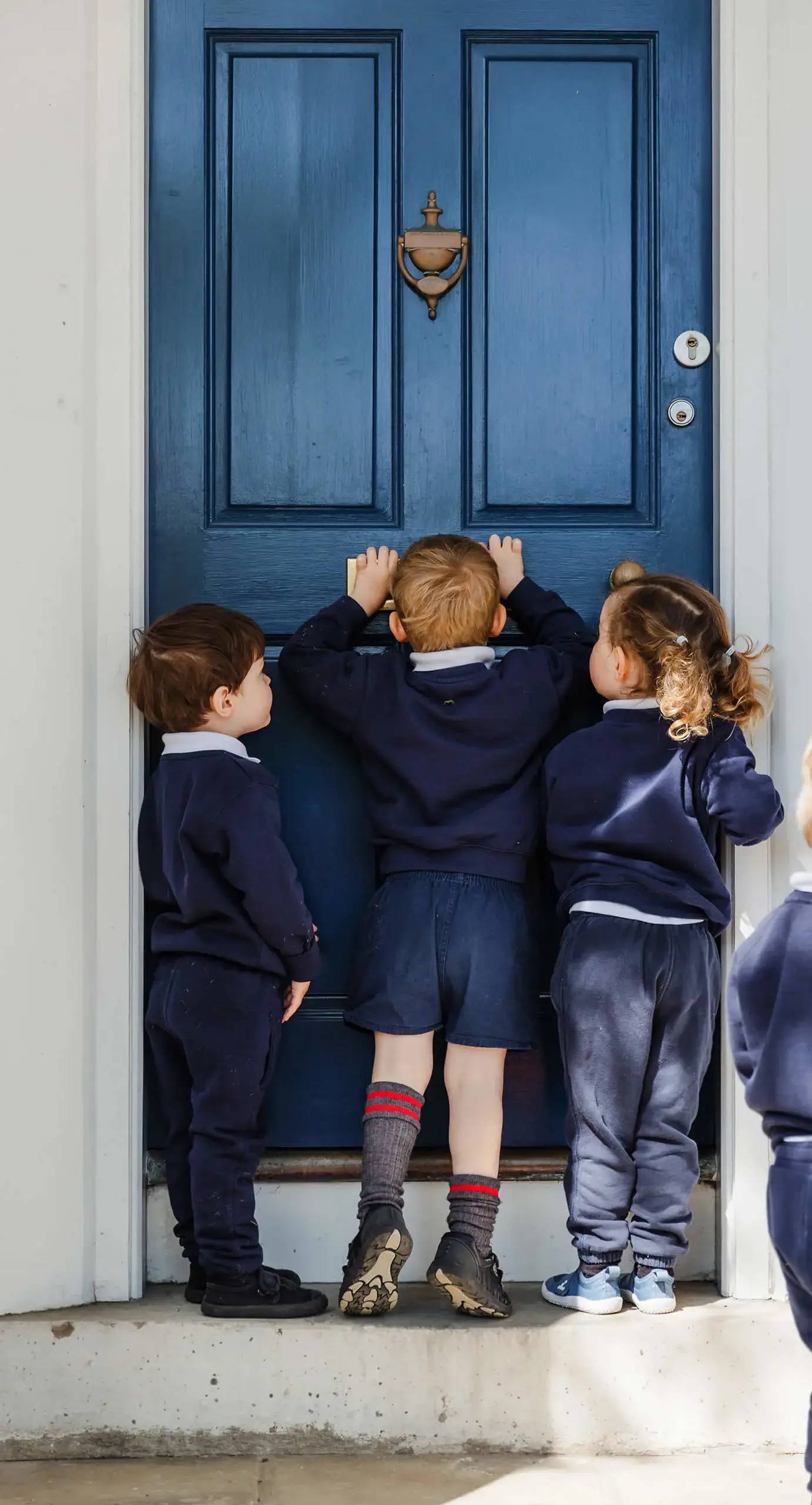 Westhill Nursey pupils look through the letterbox of Westhill Nursery's front door