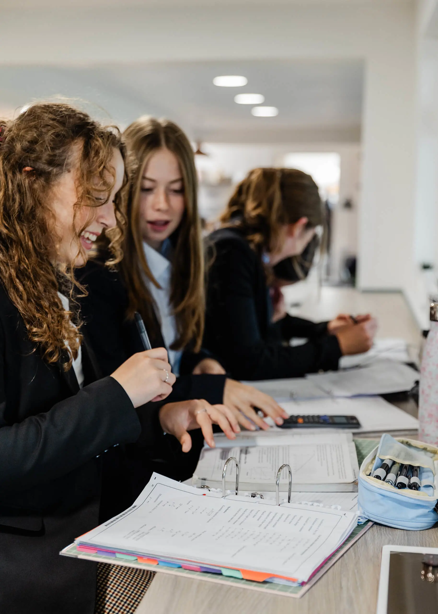 Ryde School Sixth Form pupils working together looking at folders
